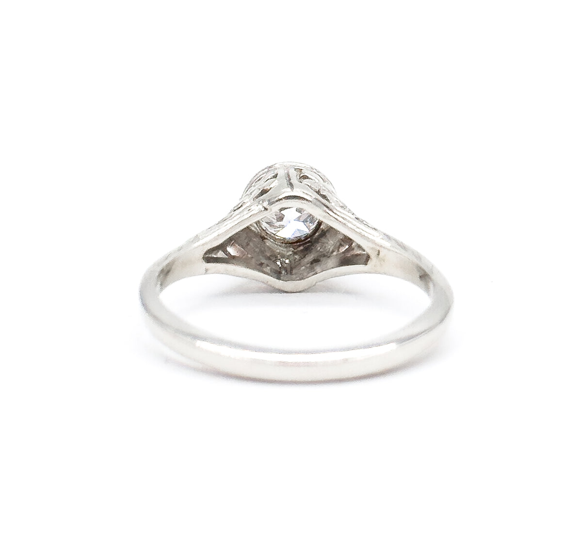 Rear view with the ring upright, looking through the open shank at the pointed underside of the gallery and the back of the diamond seated in its bezel, the plain band smooth across the bottom.