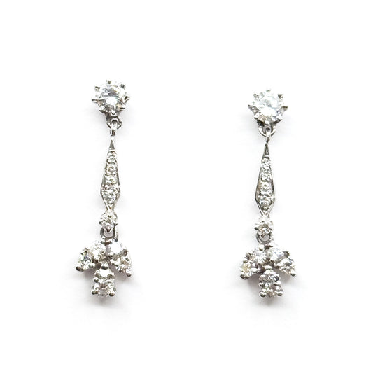 Contemporary diamond drop earrings in 14K white gold, shown as a matched pair front-on against white, each with a prong-set round stud above a tapered pavé bar and a splayed cluster of round stones.