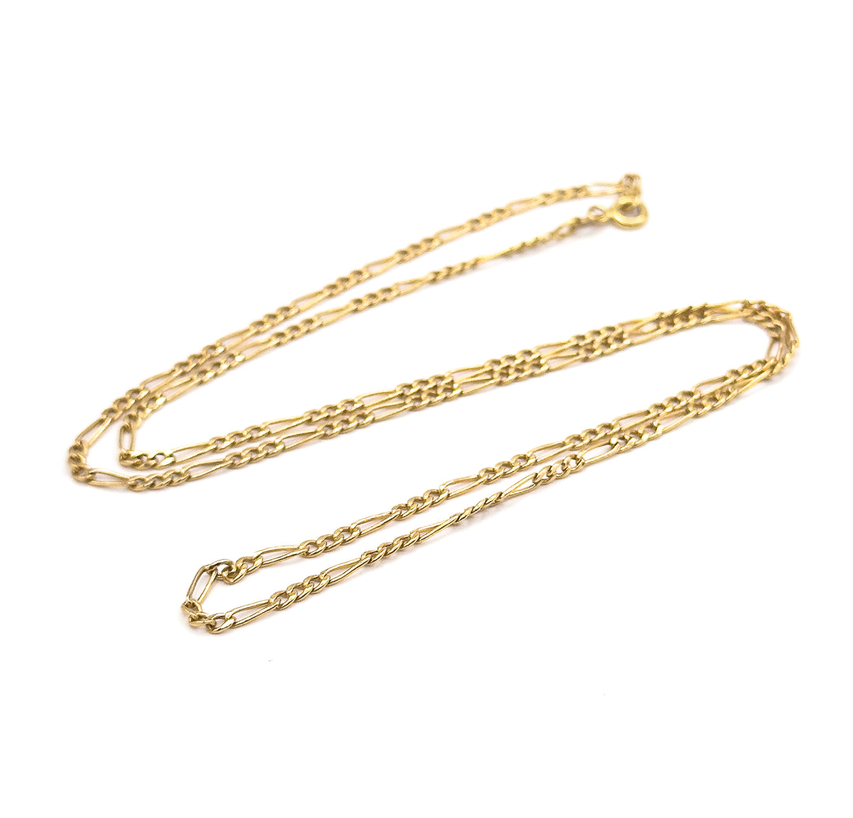 The whole necklace laid out as one long closed oval loop on white, showing its full length end to end with the spring ring clasp and jump ring resting at the top right.