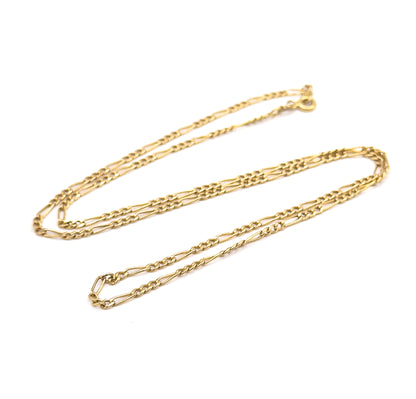 The whole necklace laid out as one long closed oval loop on white, showing its full length end to end with the spring ring clasp and jump ring resting at the top right.