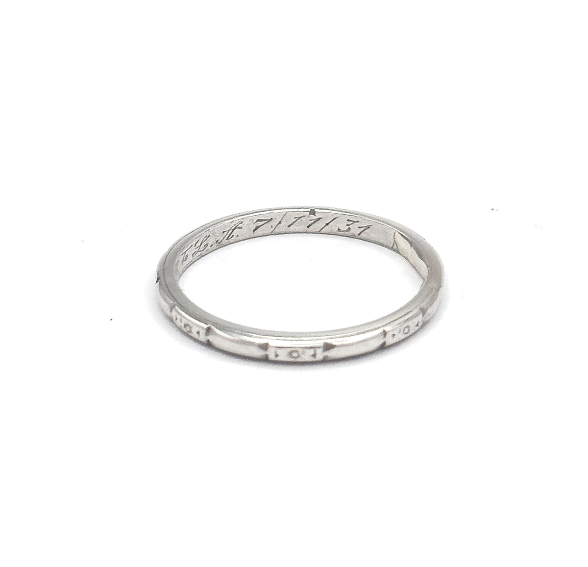 Tilted at a lower angle so the eye looks into the hoop, the cursive interior inscription reads clearly along the inner back while three etched geometric panels face forward on the outer shank.
