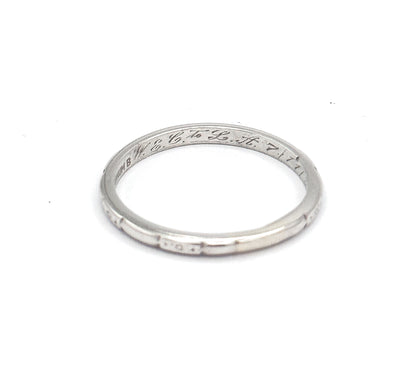 Viewed from above with the hoop lying almost flat, the inner back shows the maker's stamp ahead of the script inscription, while the near rim's etched panels run along the lower edge.