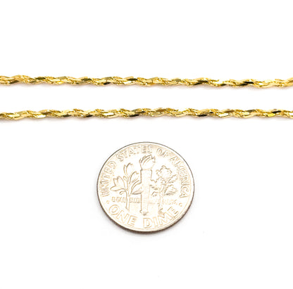 Two parallel runs of the 14K yellow gold crinkle chain laid flat on white beside a dime, showing the flat links are narrower than the coin's rim.