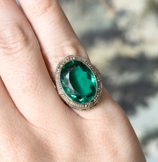 Art Deco Green Glass Paste Ring with Pearl Halo & Bow Filigree Details in White Gold
