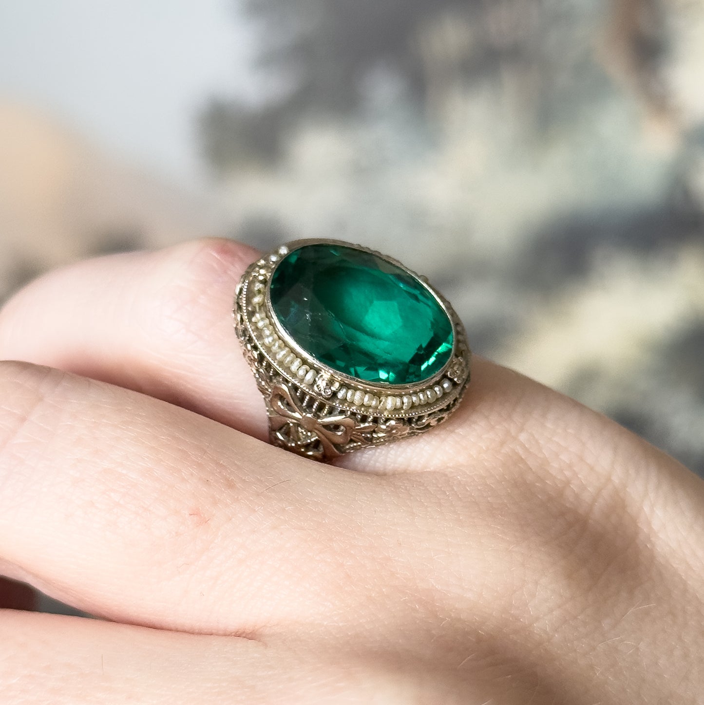 Art Deco Green Glass Paste Ring with Pearl Halo & Bow Filigree Details in White Gold
