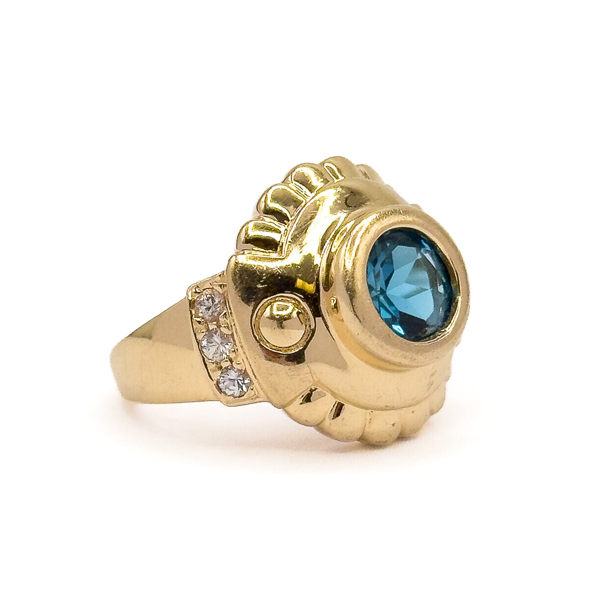 Almost the same view with slightly different angle, lower and more side-on so the tapering shank, the deep bezel wall and the three prong-set white sapphires stepping down the shoulder stand out.