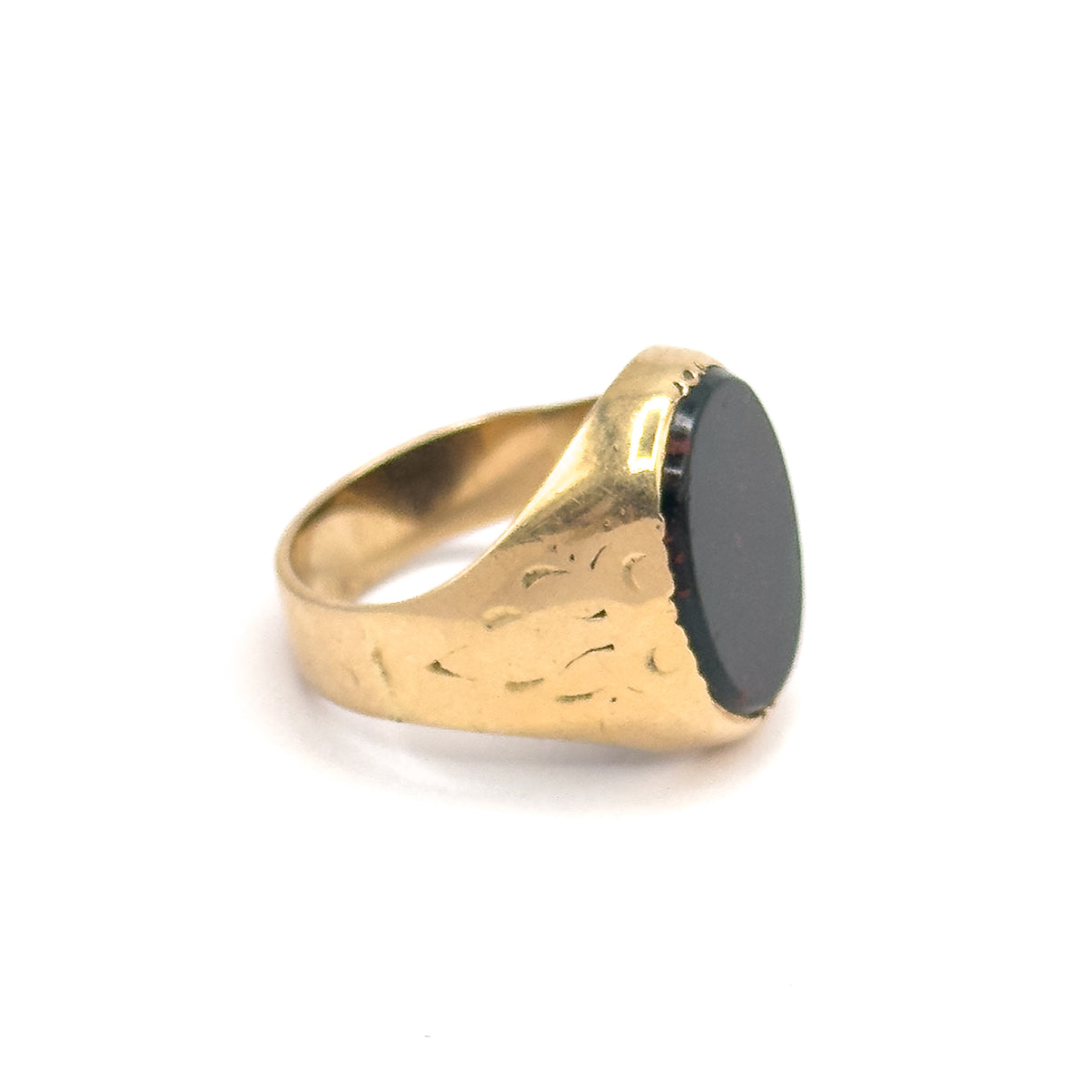 A side profile showing the oval bloodstone edge-on in its bezel, with the engraved shoulder tapering down to the narrow shank behind.