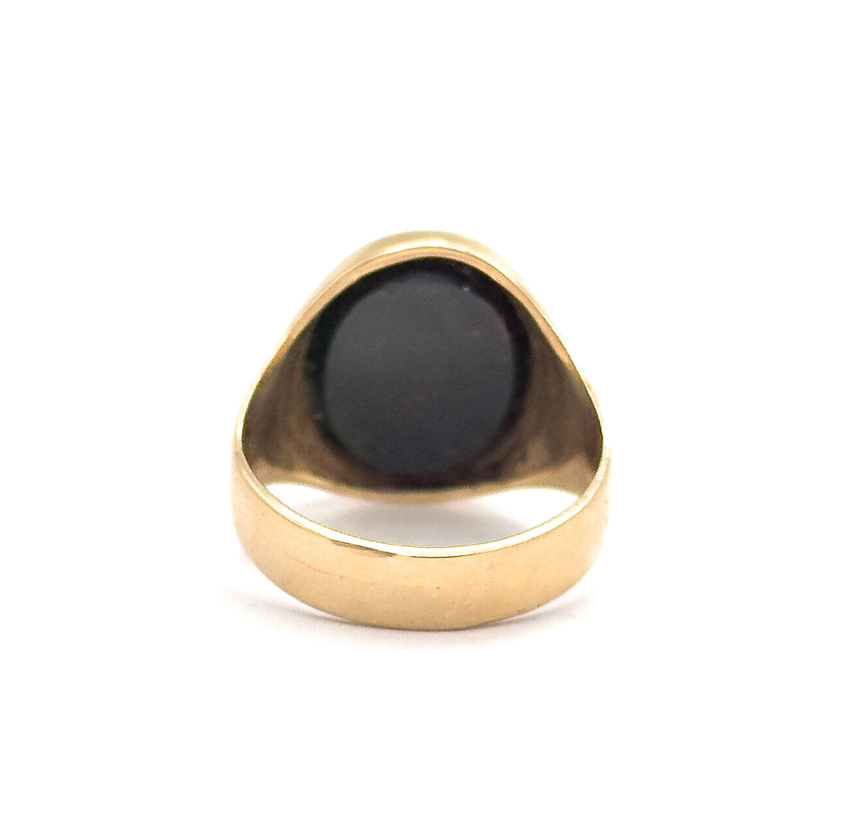Looking straight through the ring's opening from the back, the smooth inner shank curves below while the dark bloodstone fills the bezel above, its rounded gold rim outlined against white.