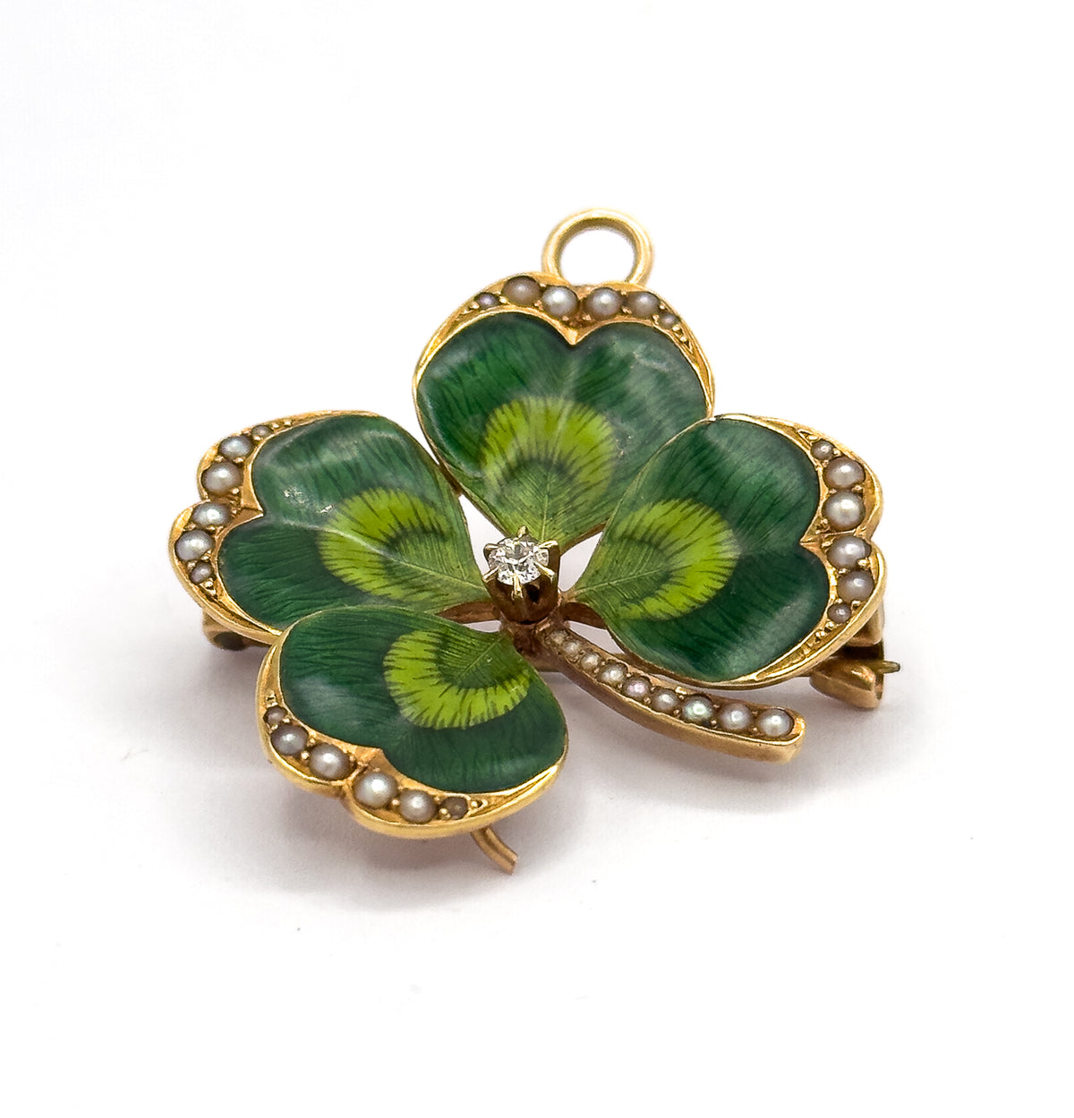 Raised three-quarter view from above with the bale ring at top, the pearl-lined stem curving out to the right between the leaves and the pin stem and catch glinting behind the right-hand leaf.