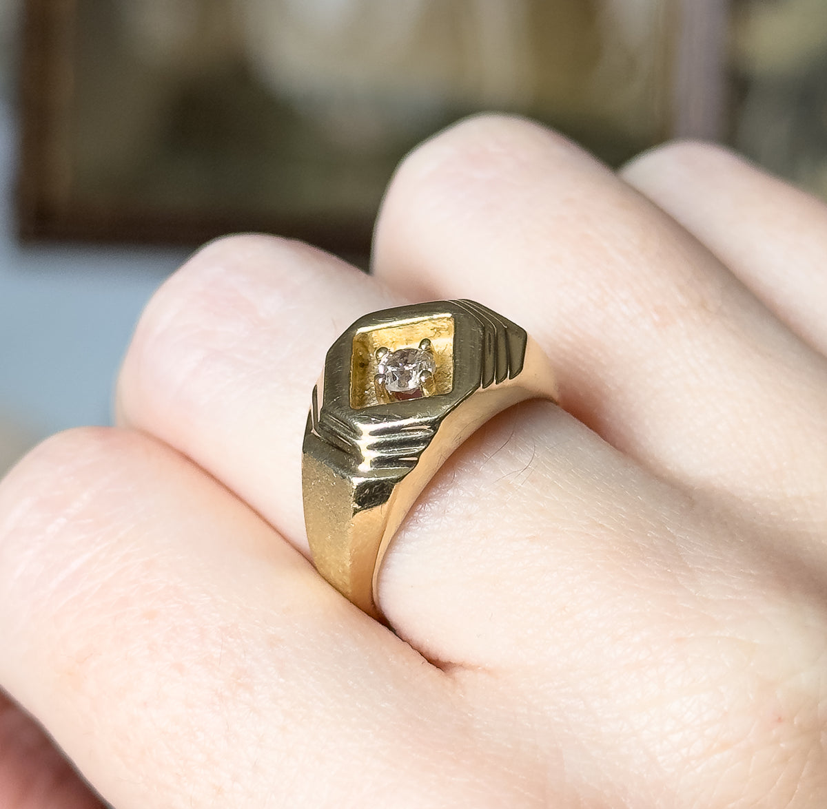 Closer still on the hand, the camera looking down onto the square recess and its four prongs, with the fine parallel grooves cut into each shoulder clearly defined against a blurred background.