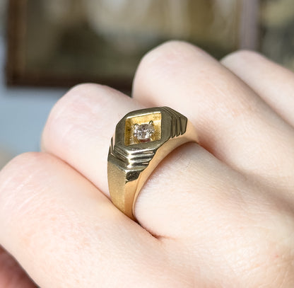 Closer still on the hand, the camera looking down onto the square recess and its four prongs, with the fine parallel grooves cut into each shoulder clearly defined against a blurred background.