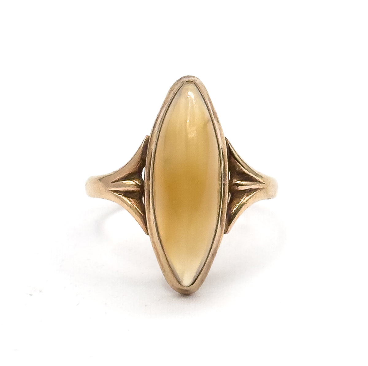 Straight-on view of the face against white, the long navette cabochon glowing honey-gold within its rose gold bezel, with ribbed fan shoulders flaring symmetrically on both sides.