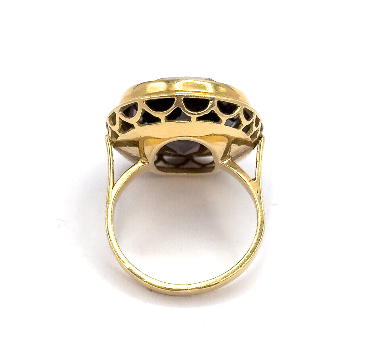 Viewed from behind and below, the open back of the setting reveals the underside of the smoky quartz through the scalloped gallery arches, with the slim yellow gold shank forming a full circle.