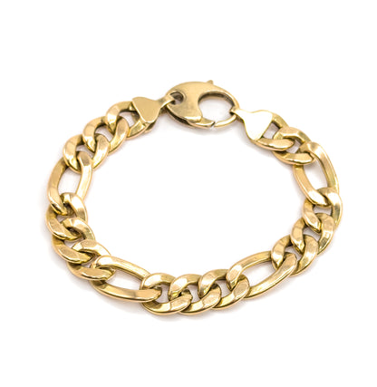 The full oval seen from slightly above and tipped away, the clasp at the top with its shaped end links, light running unevenly across the yellow gold links from front to back.