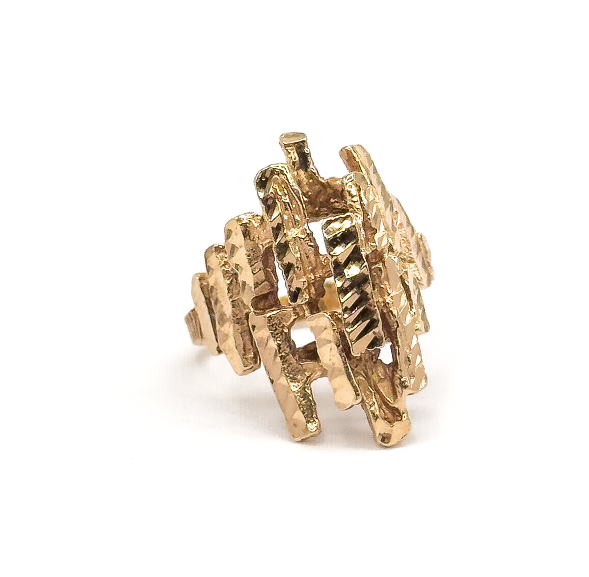 Three-quarter view standing upright on white, the open latticework of faceted yellow gold bars seen face-on with light passing through the gaps between them.