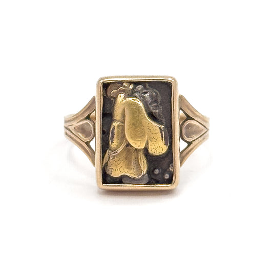 Close frontal crop on white, filling the frame with the panel so the figure's flowing robe and the small raised dots at its lower right show clearly inside the yellow gold bezel's crisp rim.