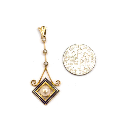 Shown upright beside a dime for scale, the pendant standing roughly as tall as two coins from fluted bail through the seed pearl bar to the cobalt enamel square.