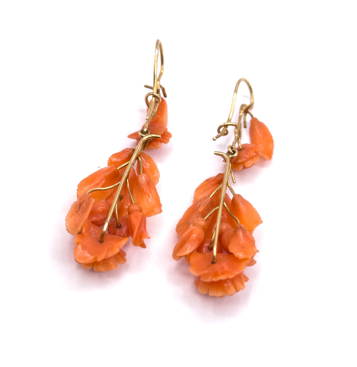 The matching earrings from the Victorian carved coral set, shown as a pair on white, each a cluster of salmon pink carved coral flowers and leaves on a 14K yellow gold stem and shepherd's hook.