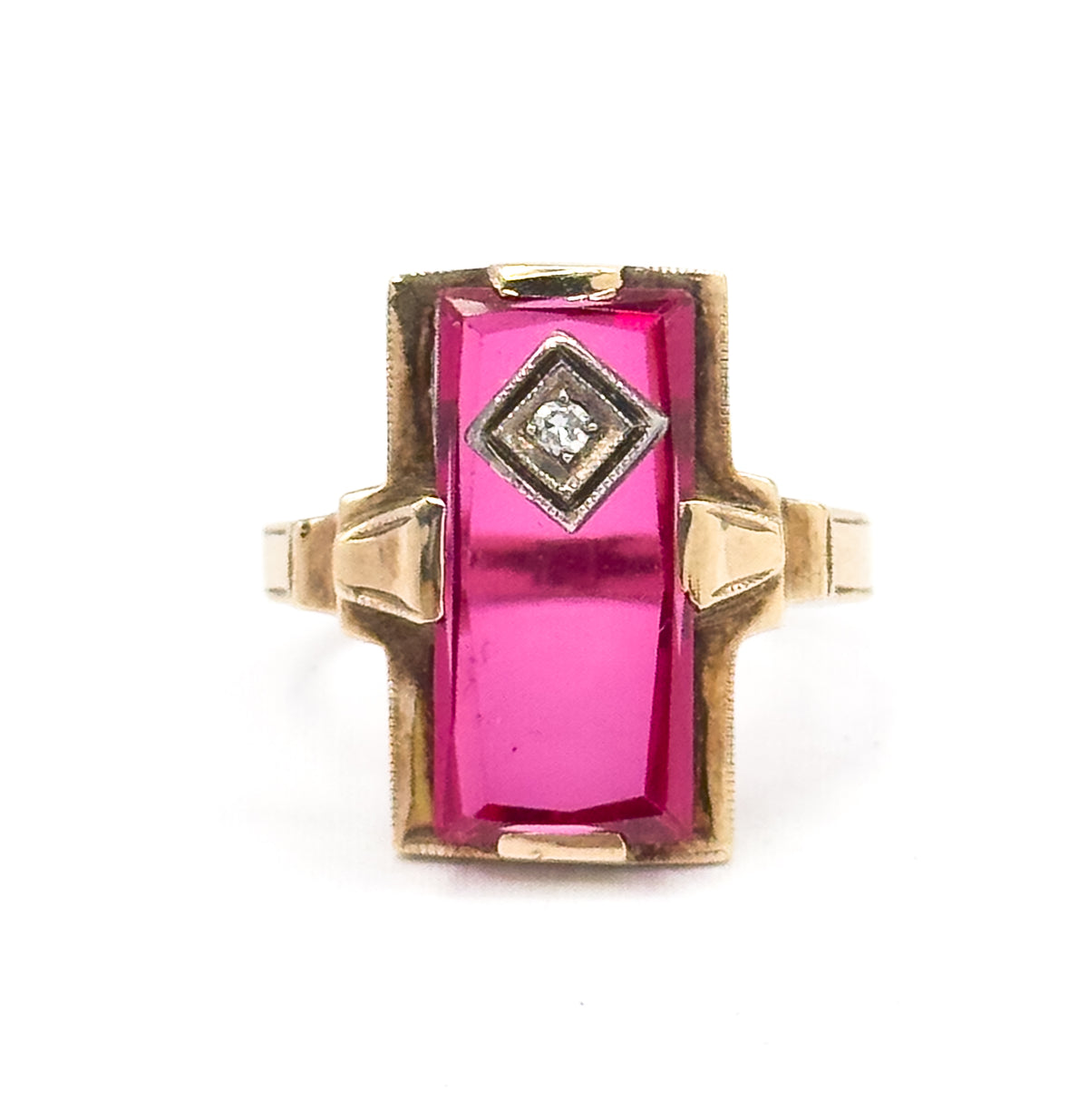 Almost the same view with slightly different angle, cropped close so the milgrain border edging the rectangular face and the grooved yellow gold shoulders either side fill the frame.