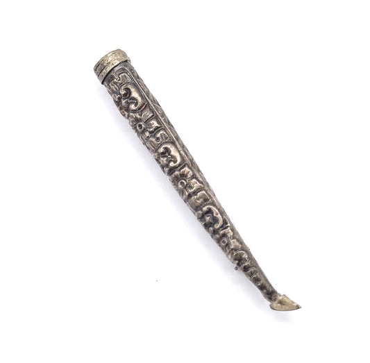 The cone shown alone on white without flowers, its collared rim at top and scrolled repoussé running the full taper to the pin stem, which curves slightly at the lower tip.