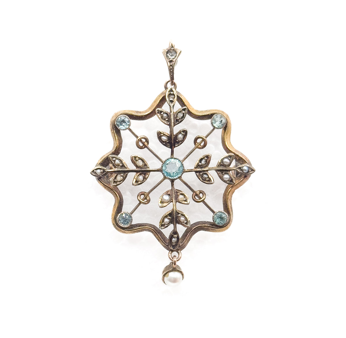 Straight-on upright view showing the whole pendant from the small stone-set bail at top, through the scalloped frame with its blue paste bezels and seed pearl leaves, to the pearl drop below.