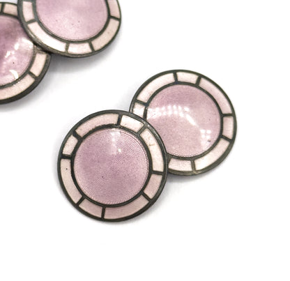 Tight crop on one pair's two faces, where the fine concentric engine-turned lines show clearly beneath the lavender enamel, the second pair cut off at the top edge.