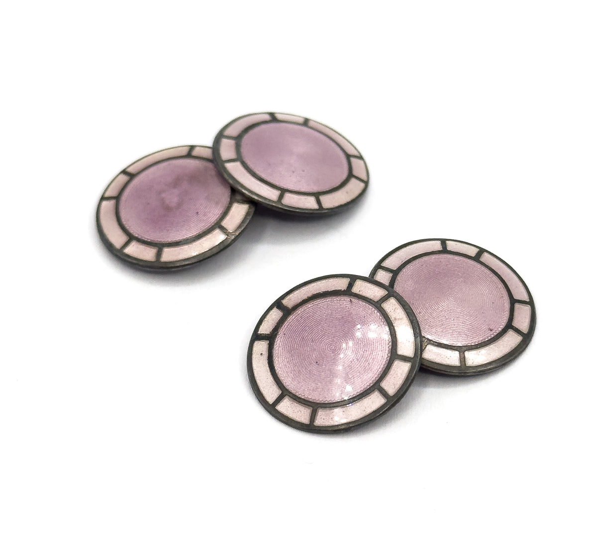 Both pairs face up on white, each disc showing a lavender guilloche centre ringed by pale enamel panels divided by silver spokes, the two pairs set diagonally apart.