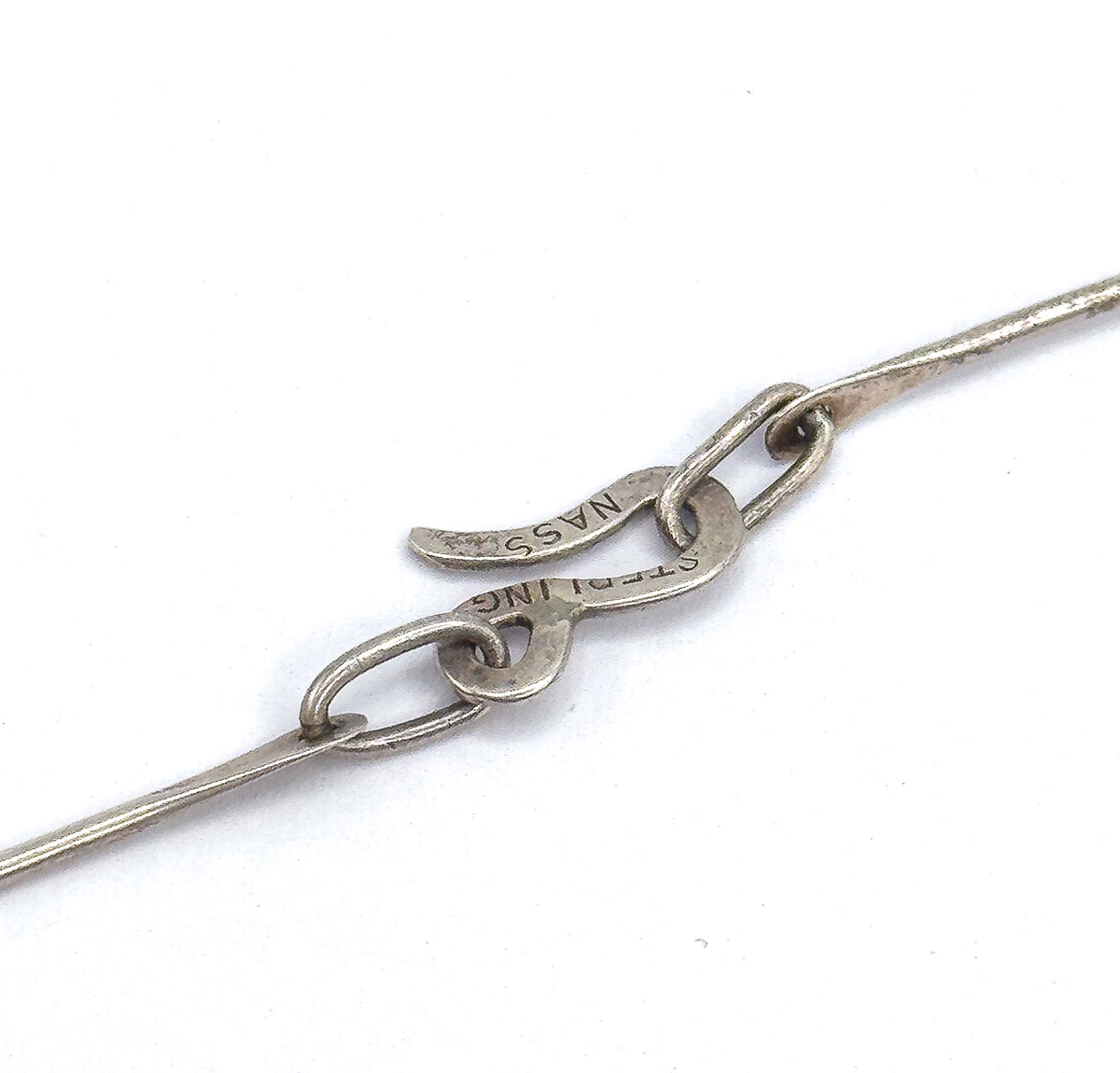 Mid-century red glass atomic necklace and earring set in sterling silver, shown here as a close-up of the necklace's hook-and-loop clasp on white, with "STERLING" and "NASS" stamps visible.