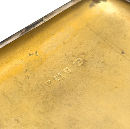 An extreme close-up of the row of small stamped marks struck into the gilt interior, each set in its own shaped punch.