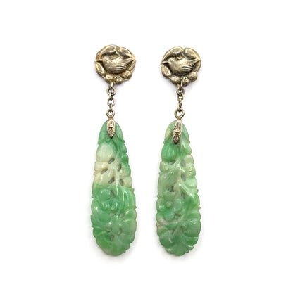 Straight-on frontal view with both earrings hanging upright and parallel, full length visible from the bird-motif tops through the chain links to the tapering carved jade drops.