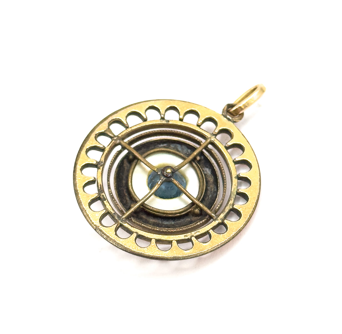The reverse of the pendant, laid flat, showing the open scalloped rim, a crossed X-shaped support bar over the blue glass bead, and the small round bail at the top.