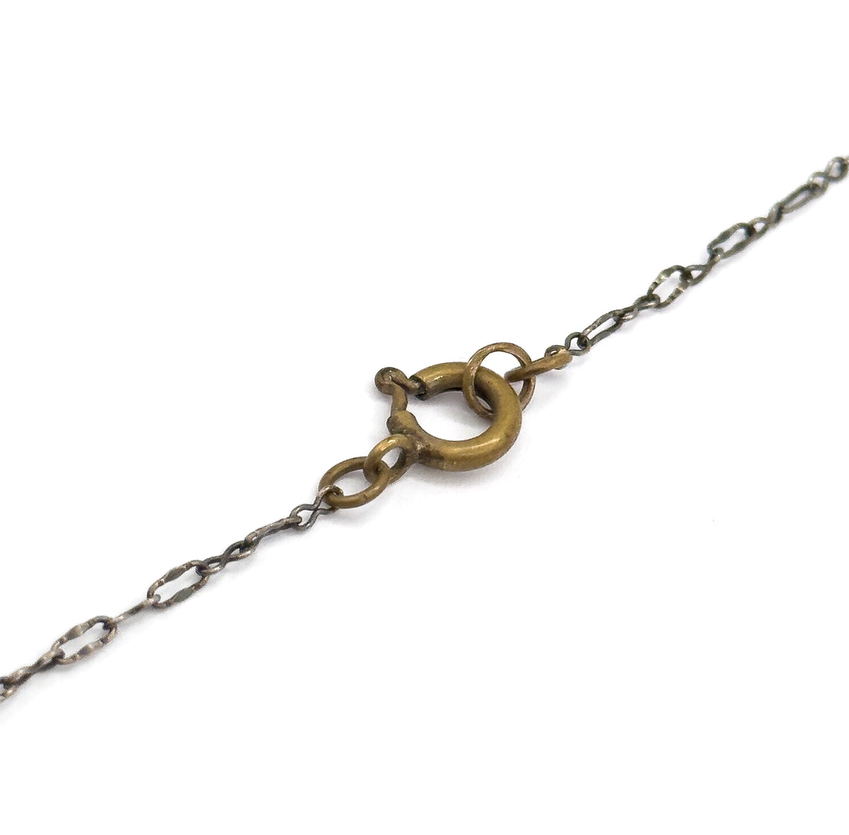 Art Deco rose quartz station necklace, shown as a close view of the base metal spring ring clasp joining the flat-link sterling silver chain across a white background.