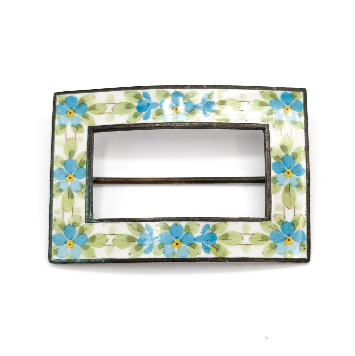 Straight-on front view with no scale object, the rectangular enamel band of blue and yellow flowers filling the frame and the pin stem crossing the open centre as a slim bar.
