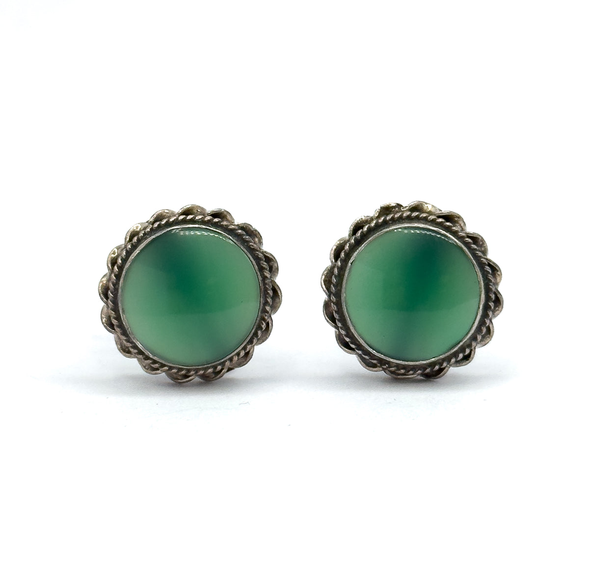 Straight-on front view of the pair, each round chrysoprase cabochon in juicy green filling its scalloped cable-textured sterling silver bezel, with no screw fittings visible from this angle.