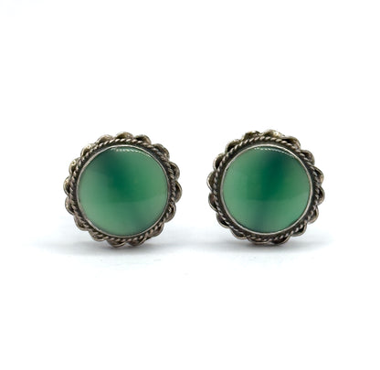 Straight-on front view of the pair, each round chrysoprase cabochon in juicy green filling its scalloped cable-textured sterling silver bezel, with no screw fittings visible from this angle.
