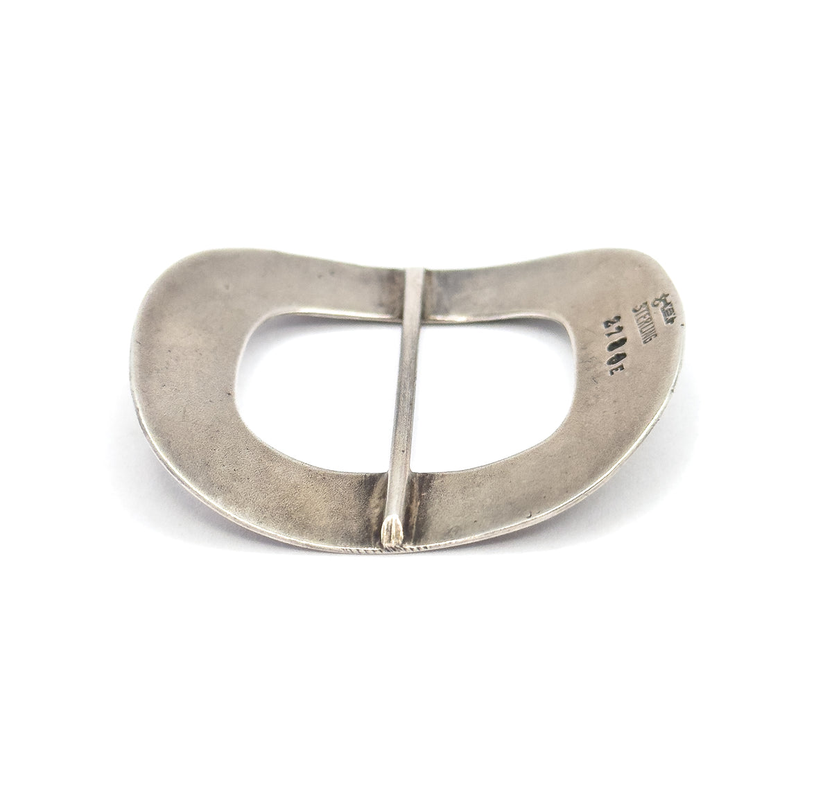The plain reverse lies flat on white, showing the smooth underside, the central bar spanning the opening, and small maker's and "sterling" stamps at one edge.