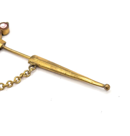 Close crop on the lower end, where the tapered sheath with its ball tip sits over the pin stem and the chain links run off to the left.
