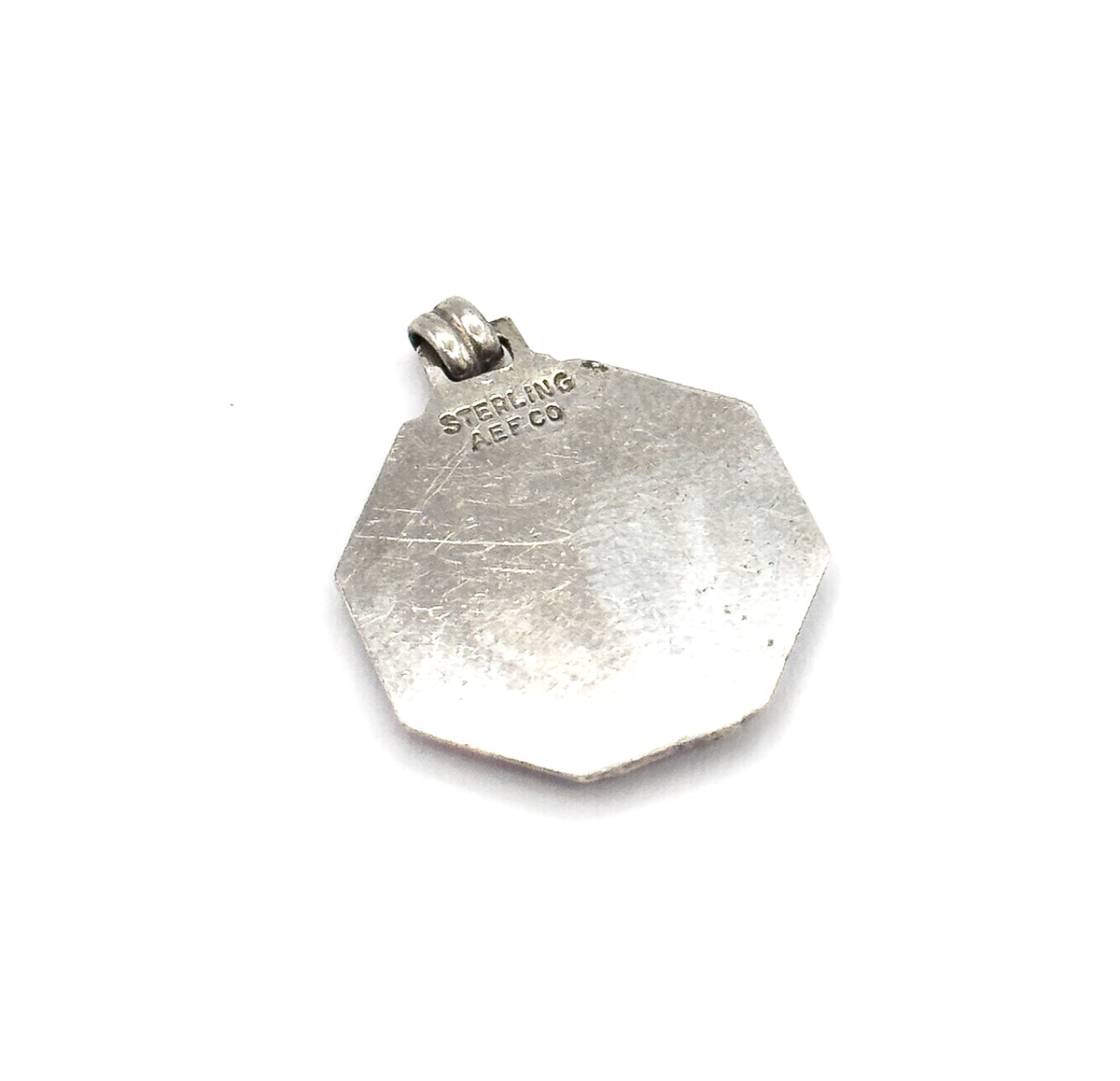 The plain sterling reverse shown face-on against white, stamped STERLING and AEF CO near the ribbed bail at the top edge.