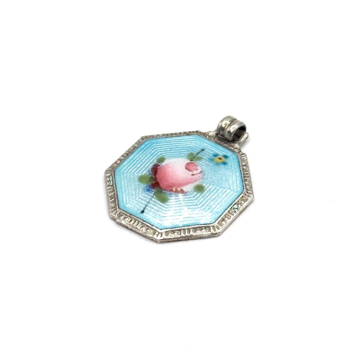 Almost the same view with slightly different angle, now showing the small blue flower and green leaves painted beside the pink rose, and the beaded edge of the silver frame.