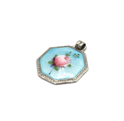 Almost the same view with slightly different angle, now showing the small blue flower and green leaves painted beside the pink rose, and the beaded edge of the silver frame.