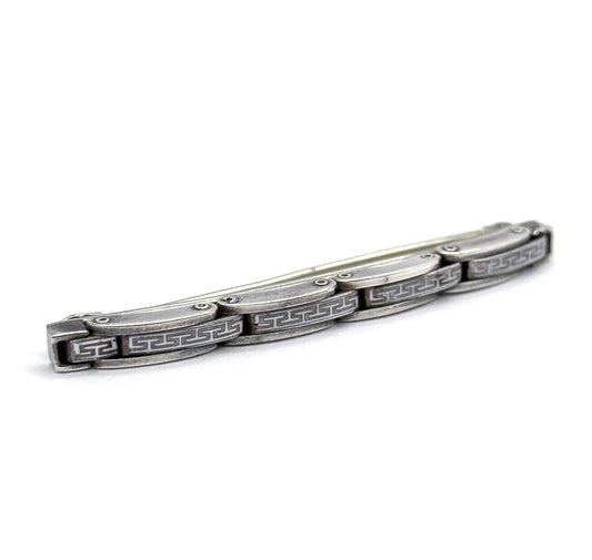 Low three-quarter view along the length of the bar from one end, the row of white square-scroll plates receding into the distance and the pin stem hidden behind the gently curved top.
