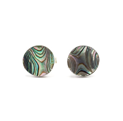 Front view of both round faces, the iridescent abalone shell curving inward within its sterling silver rim, with one post just visible behind the left cufflink.