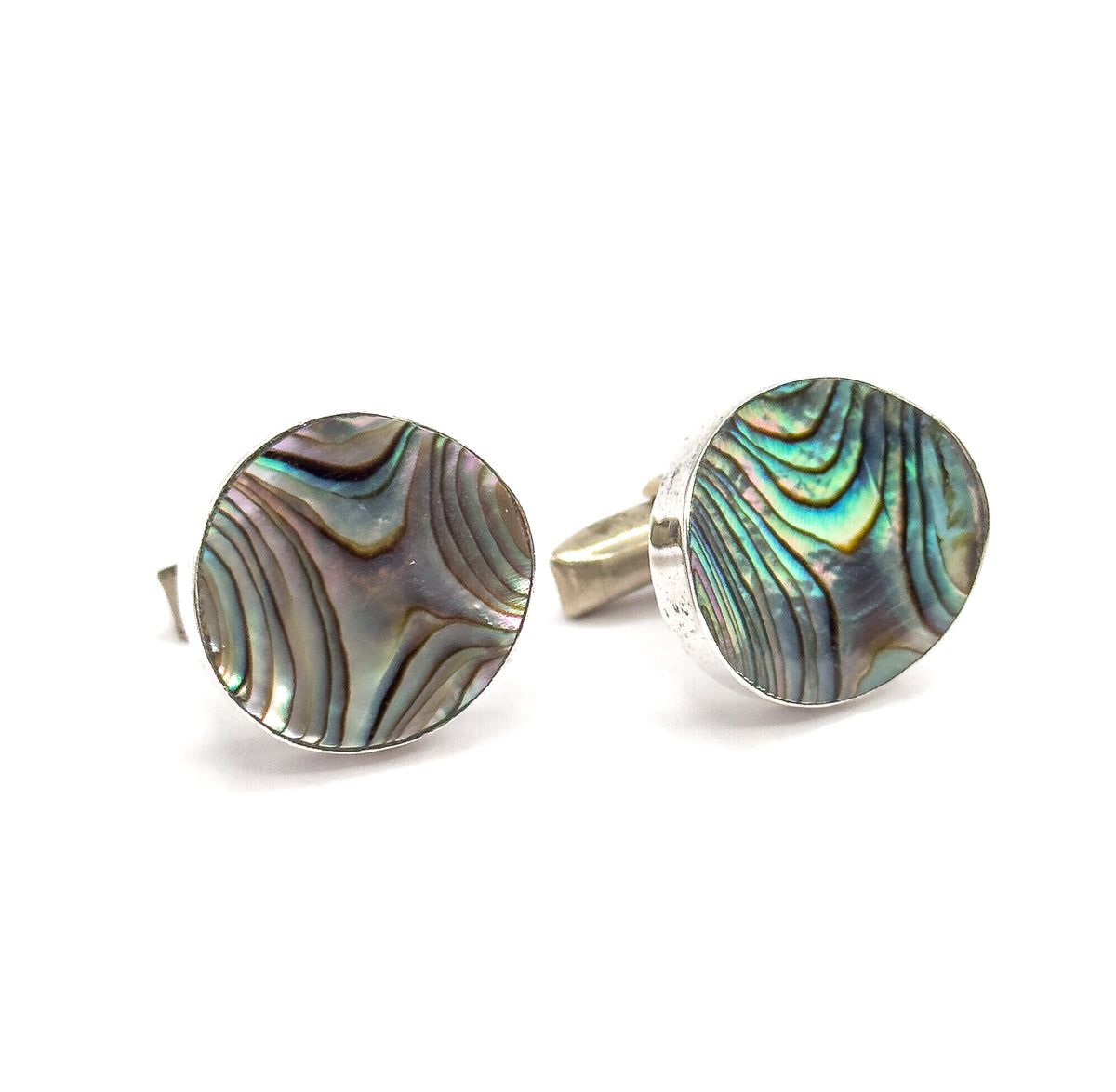 Round abalone shell cufflinks in sterling silver, shown as a pair on white, one face angled forward and the other turned to reveal the pivoting bar behind the frame.