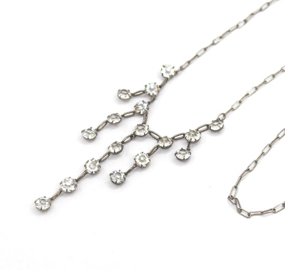 Close view of the fringe section on white, showing each paste stone held in its own small prong setting linked by short oval bars into branching, tapering strands.
