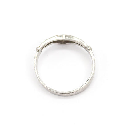 Viewed through the open circle of the band, showing the smooth inner surface of the shank and the underside of the V where the diamond settings sit.