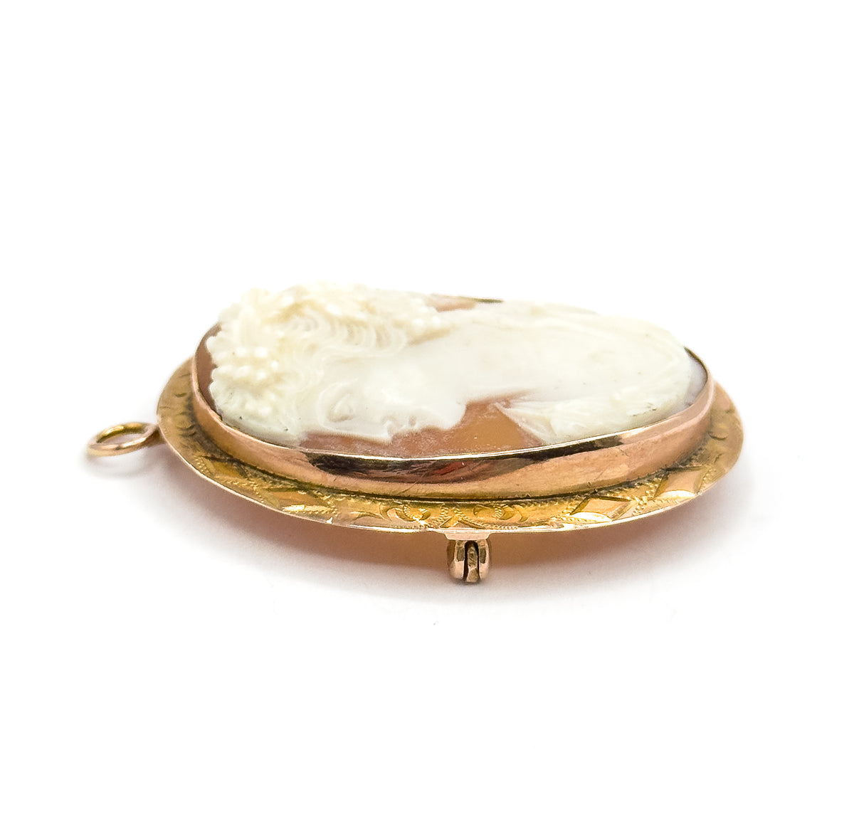 Steep low side view on white showing the frame's raised bezel in profile, the round bail jutting out at the left and the small hinged catch standing up from the reverse below.