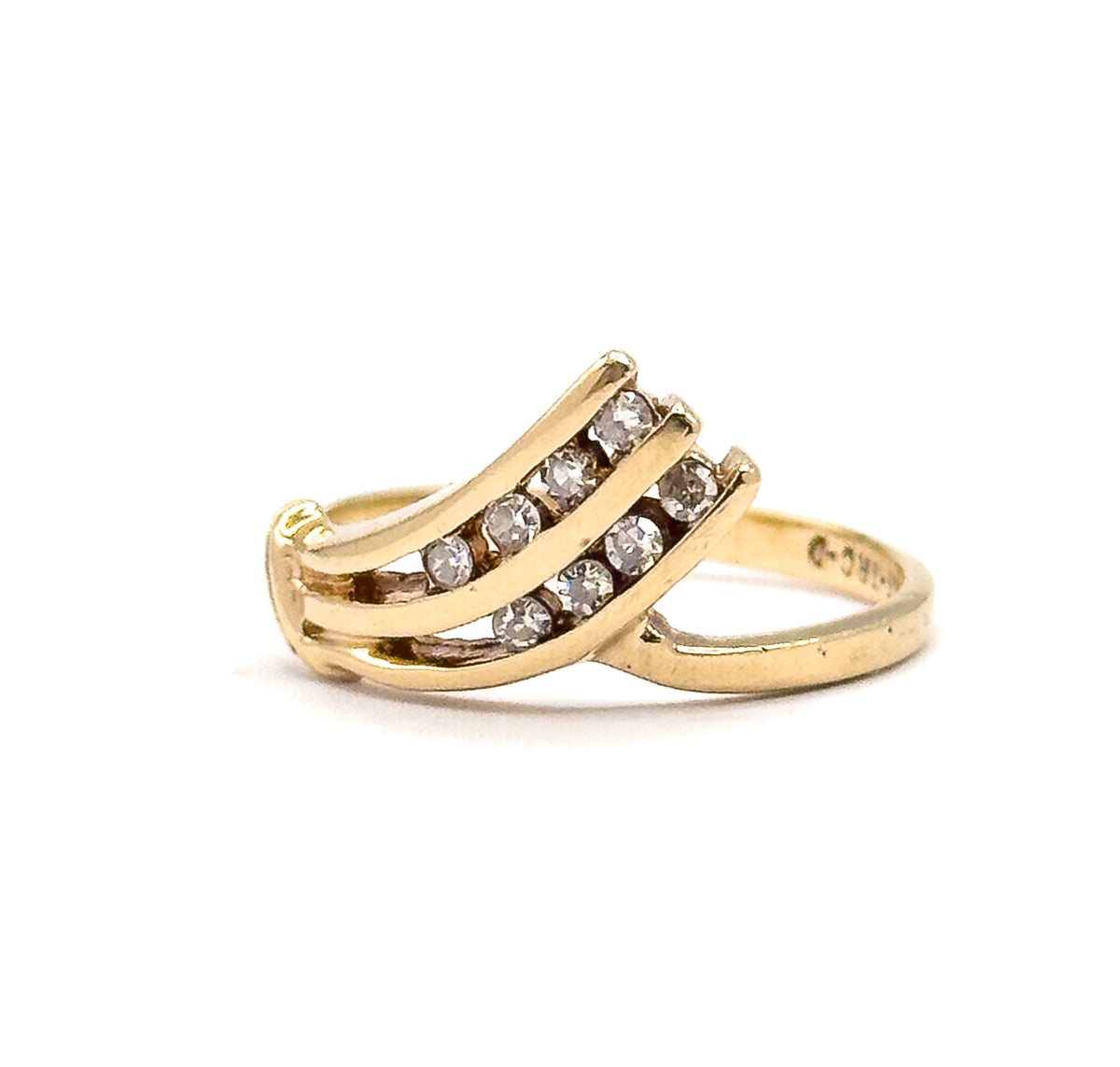 The ring stands alone against white in side profile, showing three curved yellow gold bars channel-set with small round diamonds fanning above the slim shank, which carries faint stamped marks.