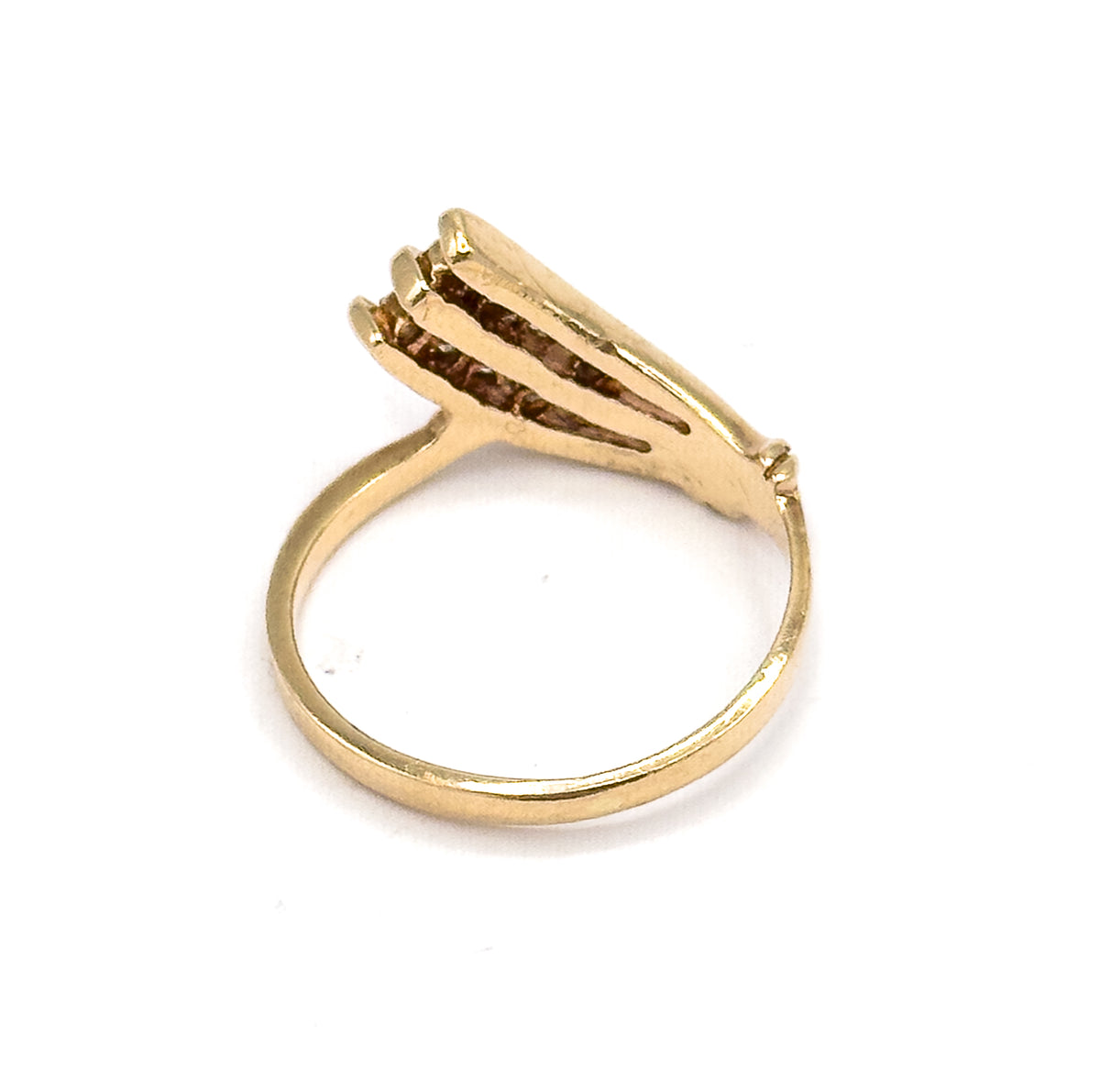 Seen from behind and slightly above, the open gallery beneath the three diamond-set bars is visible, the slim round shank sweeping away as a plain yellow gold hoop.