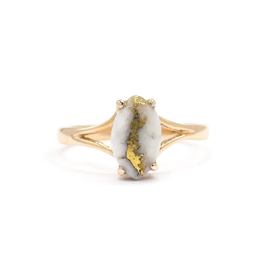 Almost the same view with slightly different angle, the marquise cabochon held by four prongs with its gold veining centred, the split shank arms meeting the plain band below.