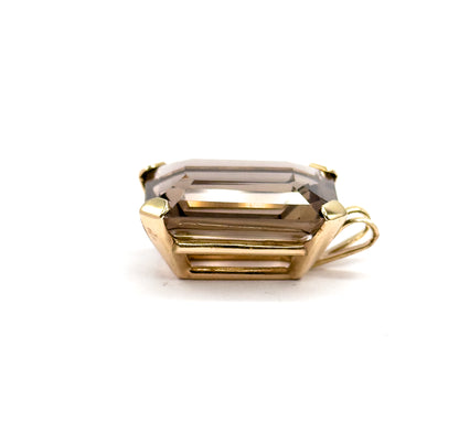 Almost the same view with slightly different angle, the pendant turned so the bail now sits at the right and the open yellow gold gallery bars beneath the stone are clearly seen.
